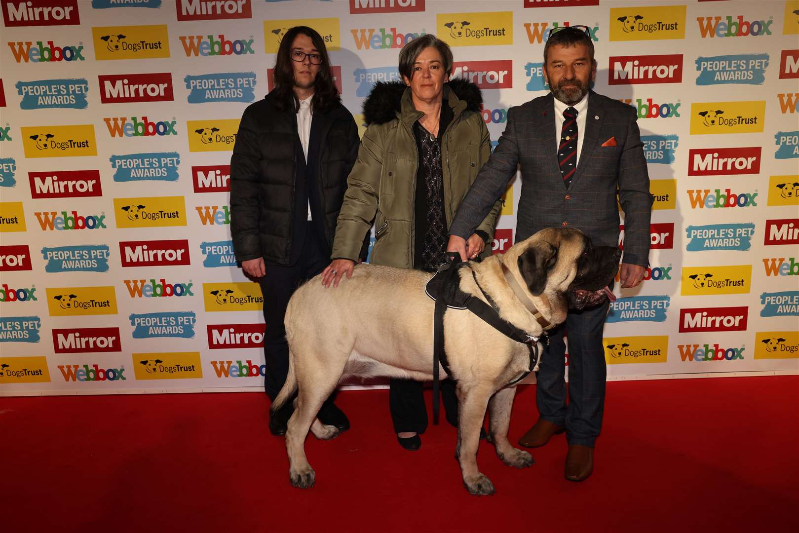 Galahad with Lindy and Colin Dimmock and their son Matthew, from Rochester, attends the People’s pet awards 2021 Grosvenor House Hotel 9 December 2021 red carpet. Picture: People's Pet Awards