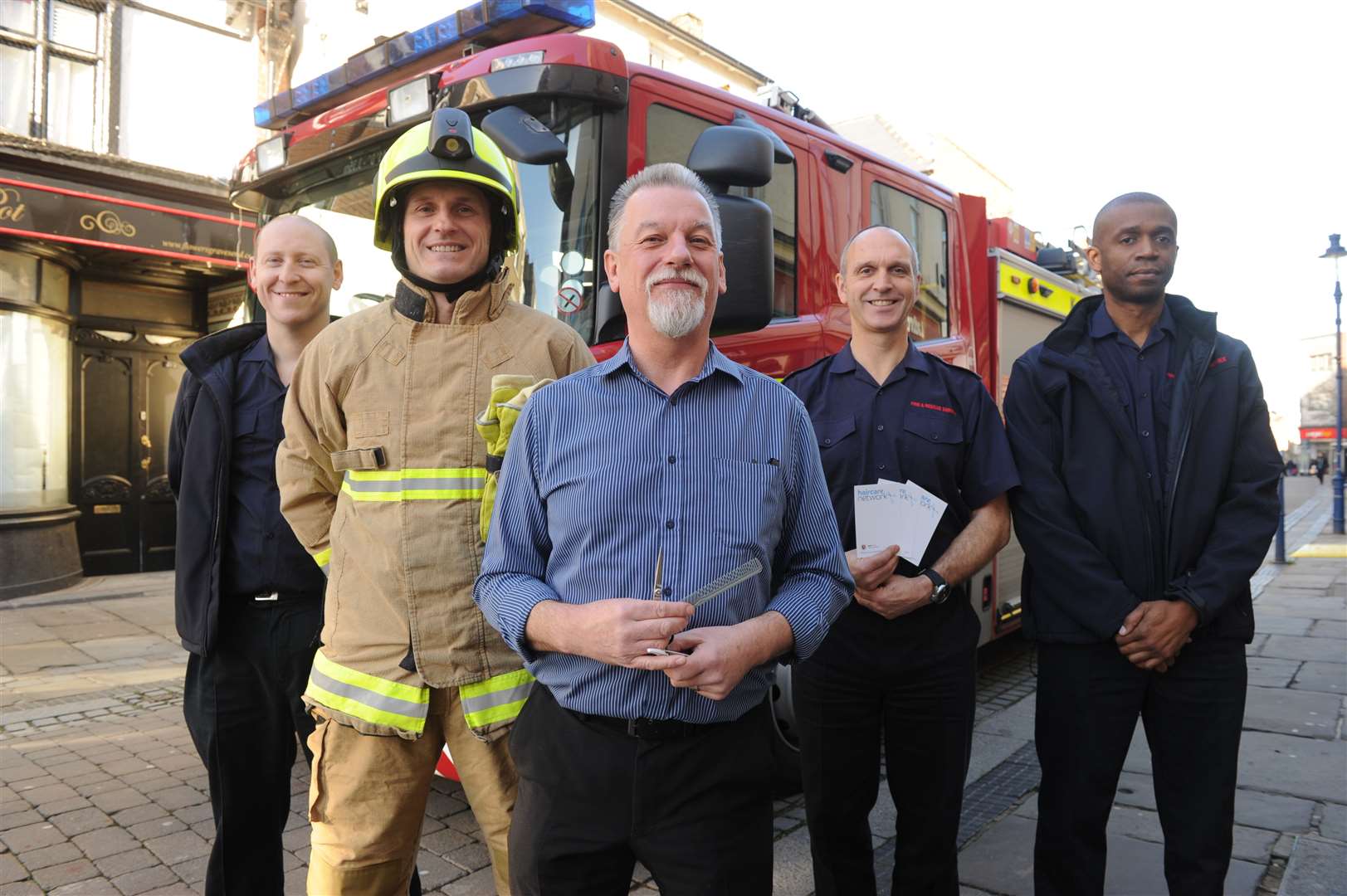 Kent Fire Fire & Rescue with Fishers Barbers owner Paul Kennett.