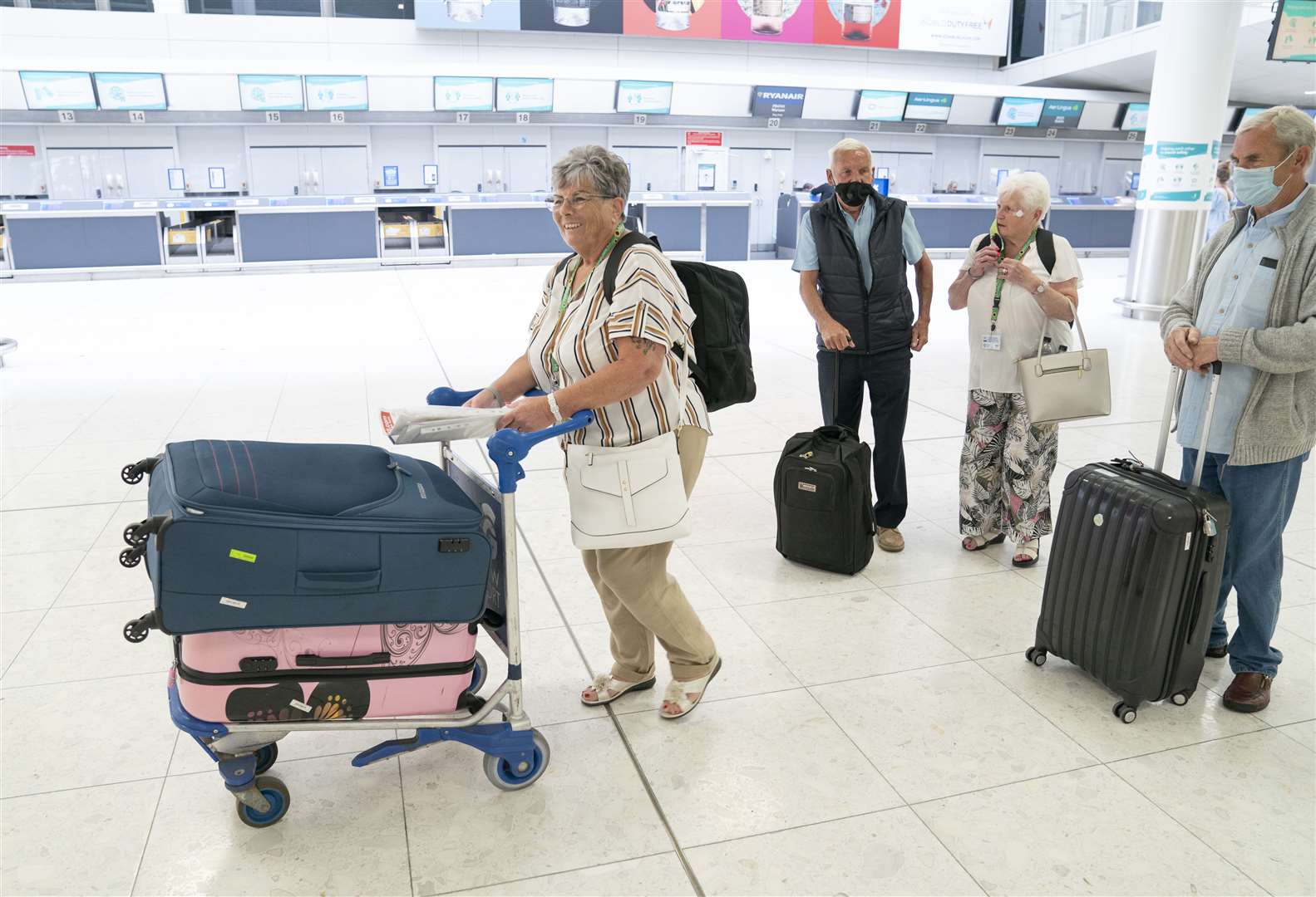 (left to right) Maggie Smith, Bernard Smith, Rosemary Gallacher and Ralph Smith head to the Jet2 check-in desk at Glasgow Airport (Jane Barlow/PA)