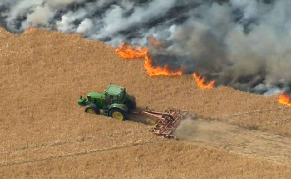 Aerial footage of the fire shows Mr Alexander's ploughing through the spring barley to create a buffer around the inferno. Picture: BBC