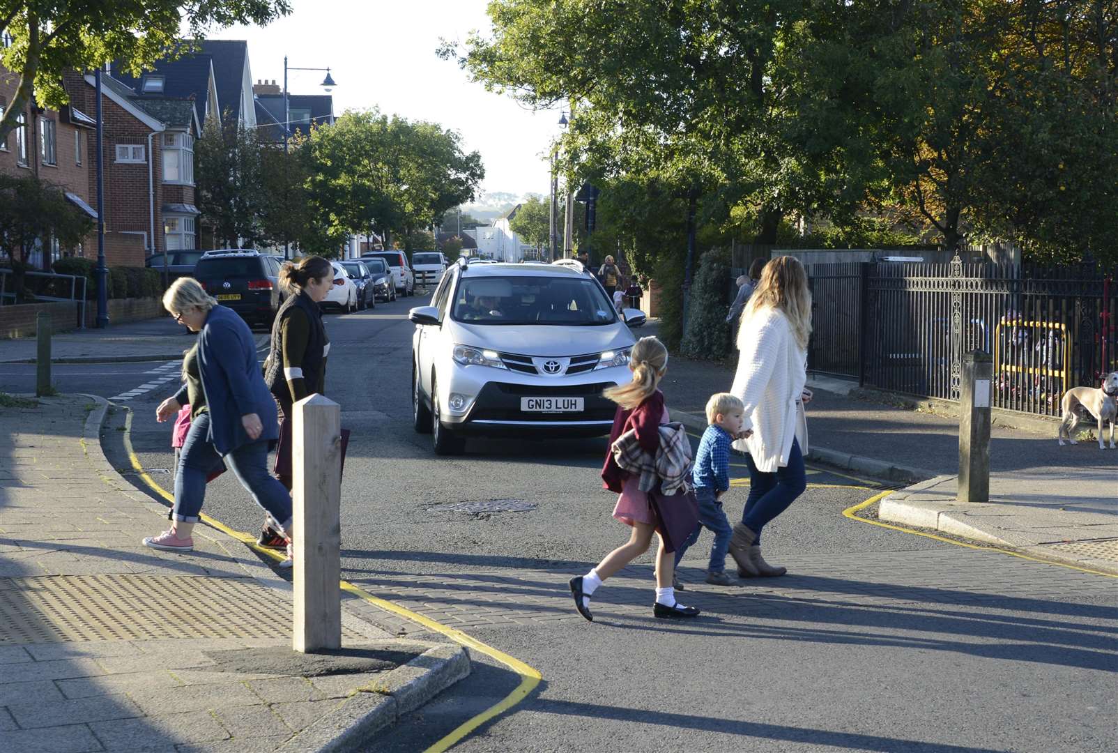 Families crossing Cromwell Road, outside Westmeads Community Infant school