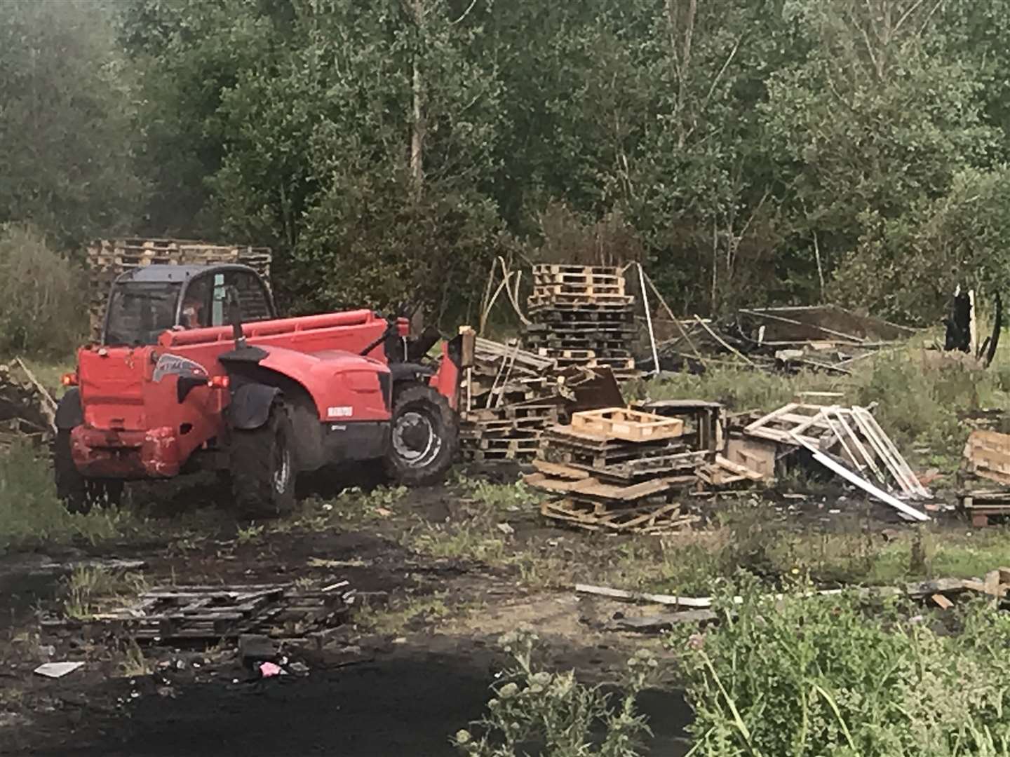 In June, contractors cleared wood gathered for a July 11 bonfire at Lismore Street in Belfast after the local community agreed to cancel the lighting of this year’s pyre due to the coronavirus pandemic (Rebecca Black/PA)