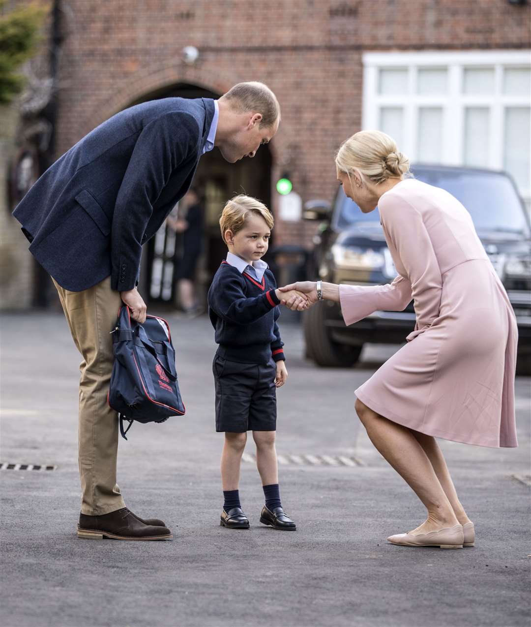 George shakes hands with Helen Haslem, head of the lower school on his first day at Thomas’s Battersea (Richard Pohle/The Times/PA)