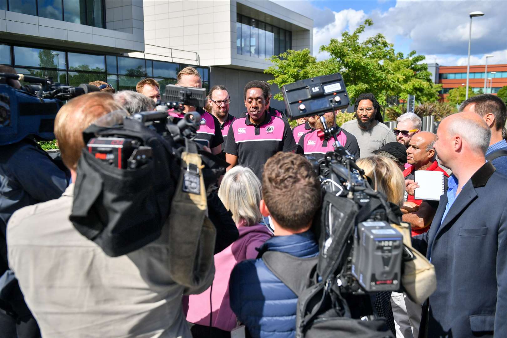 Mr Macharia (centre) speaks to the media during his deportation campaign (Ben Birchall/PA).