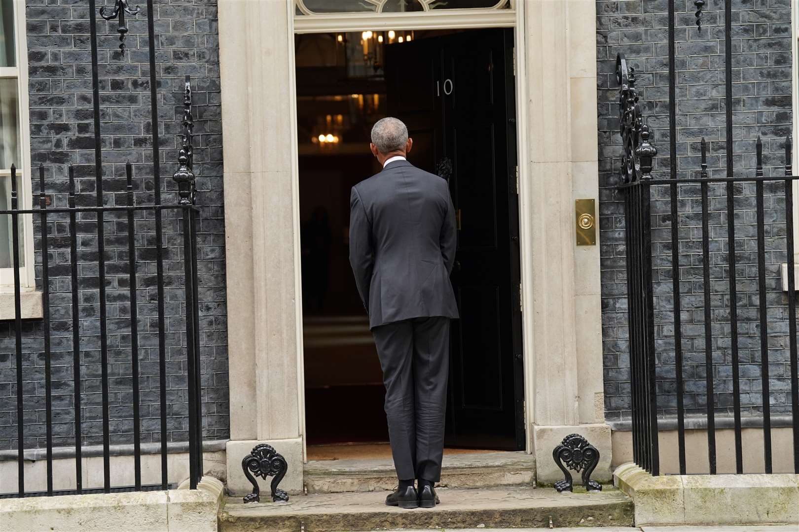 Former US president Barack Obama waits outside 10 Downing Street after arriving for a meeting with Rishi Sunak (Stefan Rousseau/PA Wire)