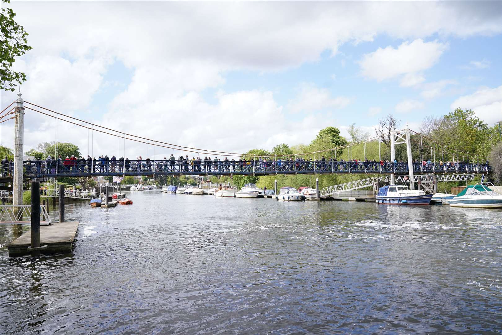 People gather on the footbridge at Teddington Lock to try and spot the Minke whale (Yui Mok/PA)