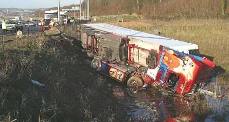 The lorry lies on its side in the ditch. Picture: MIKE MAHONEY