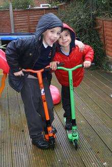 Nathan, seven and Daniel Laraman six are reunited with their scooters