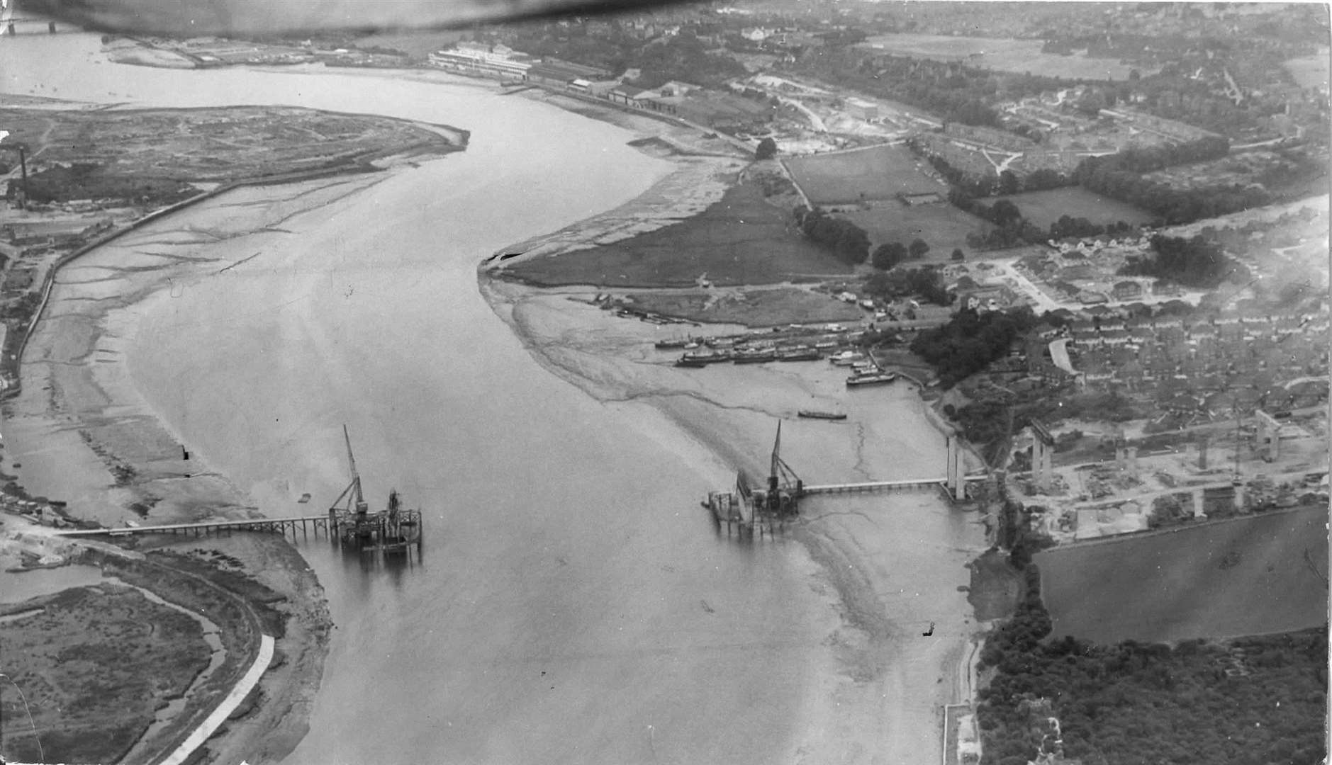 A 1961 shot of the site where the Medway Bridge now stands, but minus the bridge. The cranes positioned on each bank will soon bridge the gap and become part of the M2