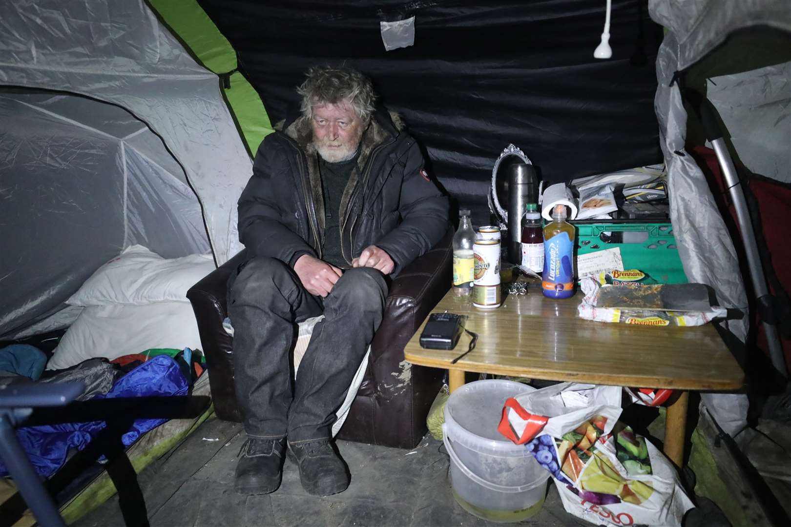 Rough sleeper Gerry Wall is visited by Inner City Helping Homeless outreach volunteer Avril Darker in his tent in Dublin’s affluent Clontarf area (Niall Carson/PA)