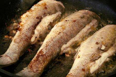 Dave Wise cooks sea bass caught in the estuary at Darnet Island.