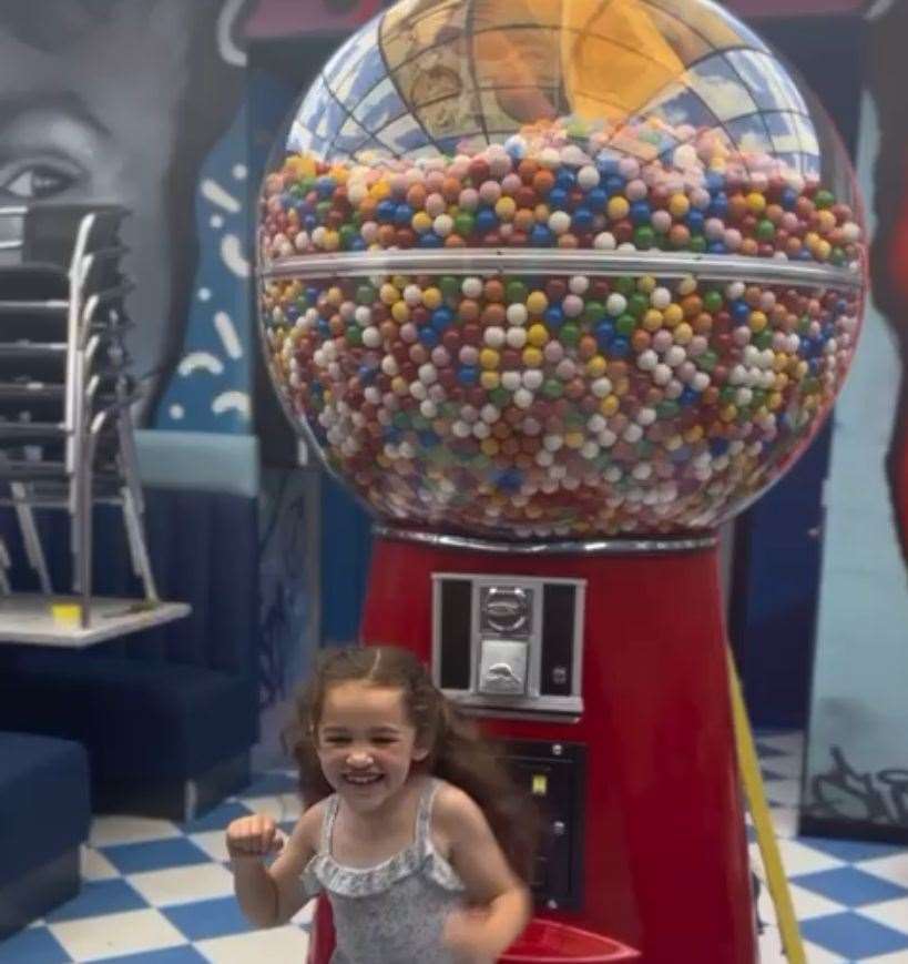William Brown's sister Pearl next to the UK's biggest gumball machine at the Folkestone shop. Picture: Will Brown Sr