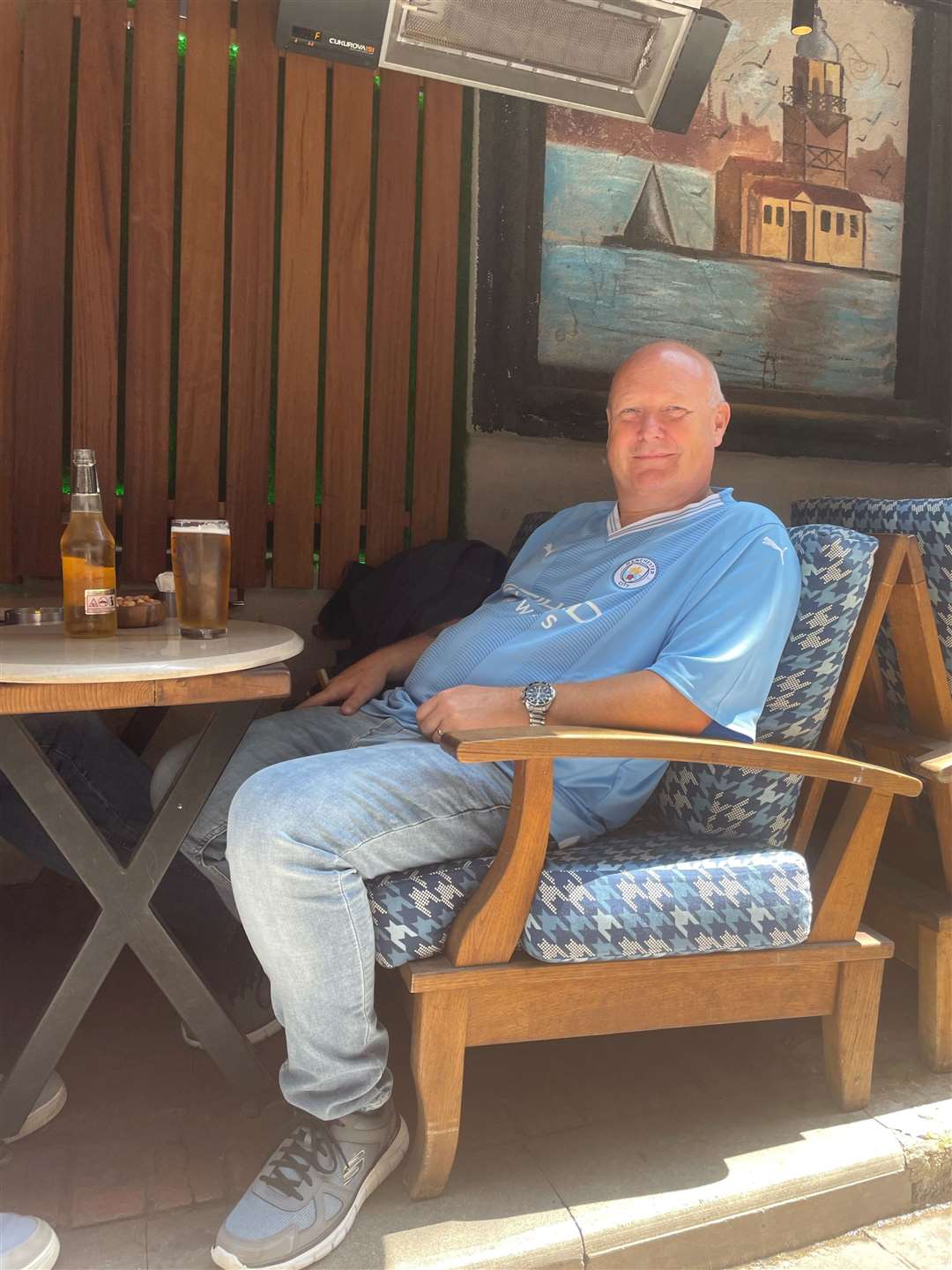 Man City fan Tony Prince, 57, from Blackley, Manchester, enjoys a drink near Taksim Square (Luke O’Reilly/PA)