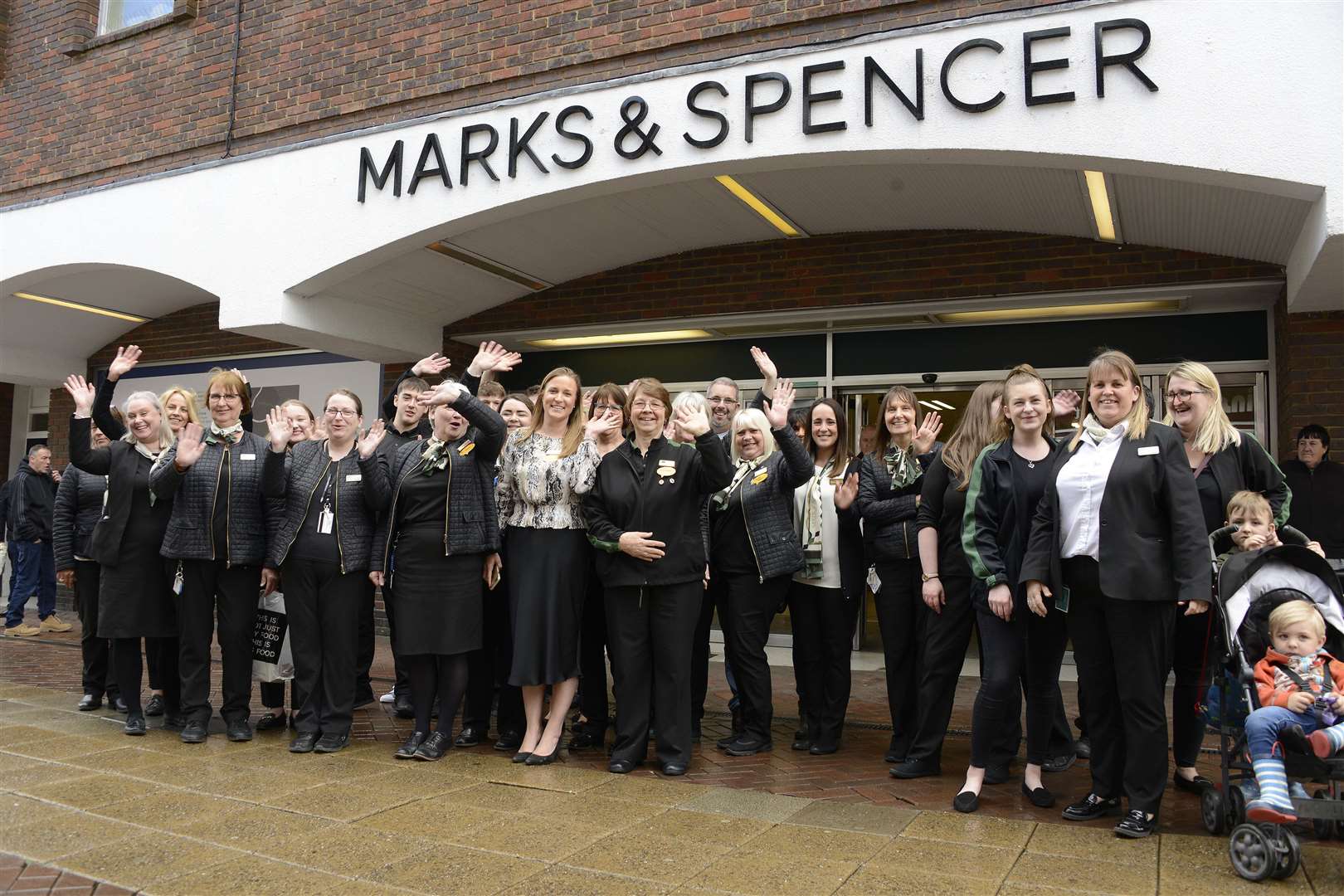 Staff pose for a picture outside the store on its final day in 2019