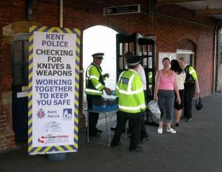 Police using a mobile metal archway to detect knives and knuckle dusters