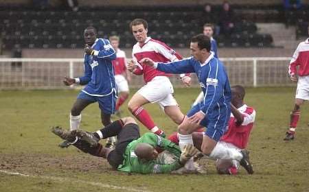 Goal hero Moses Jjunju looks on as the Redbridge keeper saves bravely at the feet of Peter Benevides. Picture: GARY BROWNE