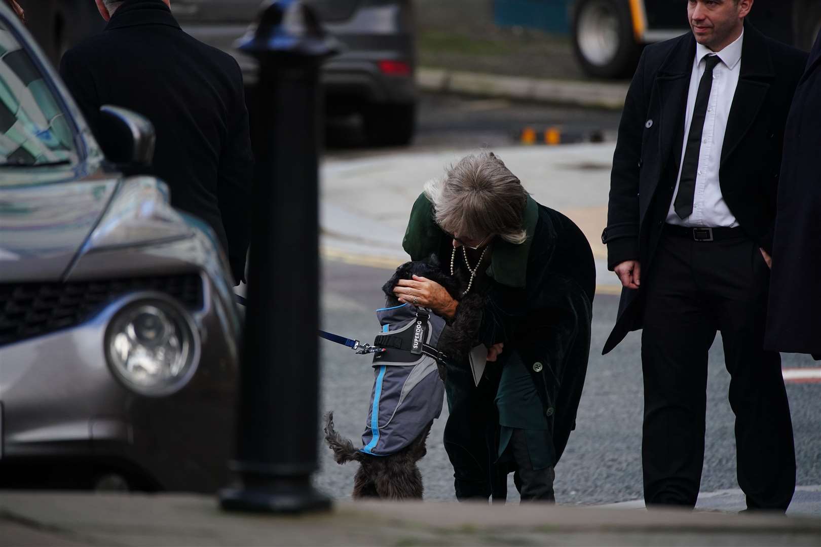 Actress Sue Johnston pets Billy the Schnauzer, former Brookside actor Dean Sullivan’s dog, as she arrives for his funeral for at Liverpool Parish Church (Our Lady And St Nicholas) (Peter Byrne/PA)