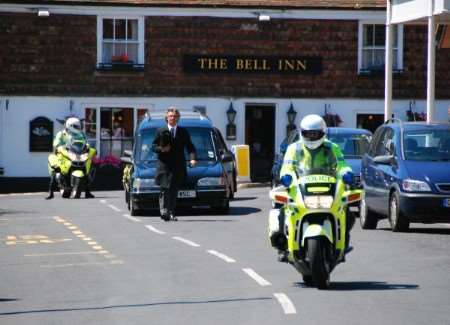 The funeral cortege makes its way to St Mary's Church, Minster, flanked by police outriders