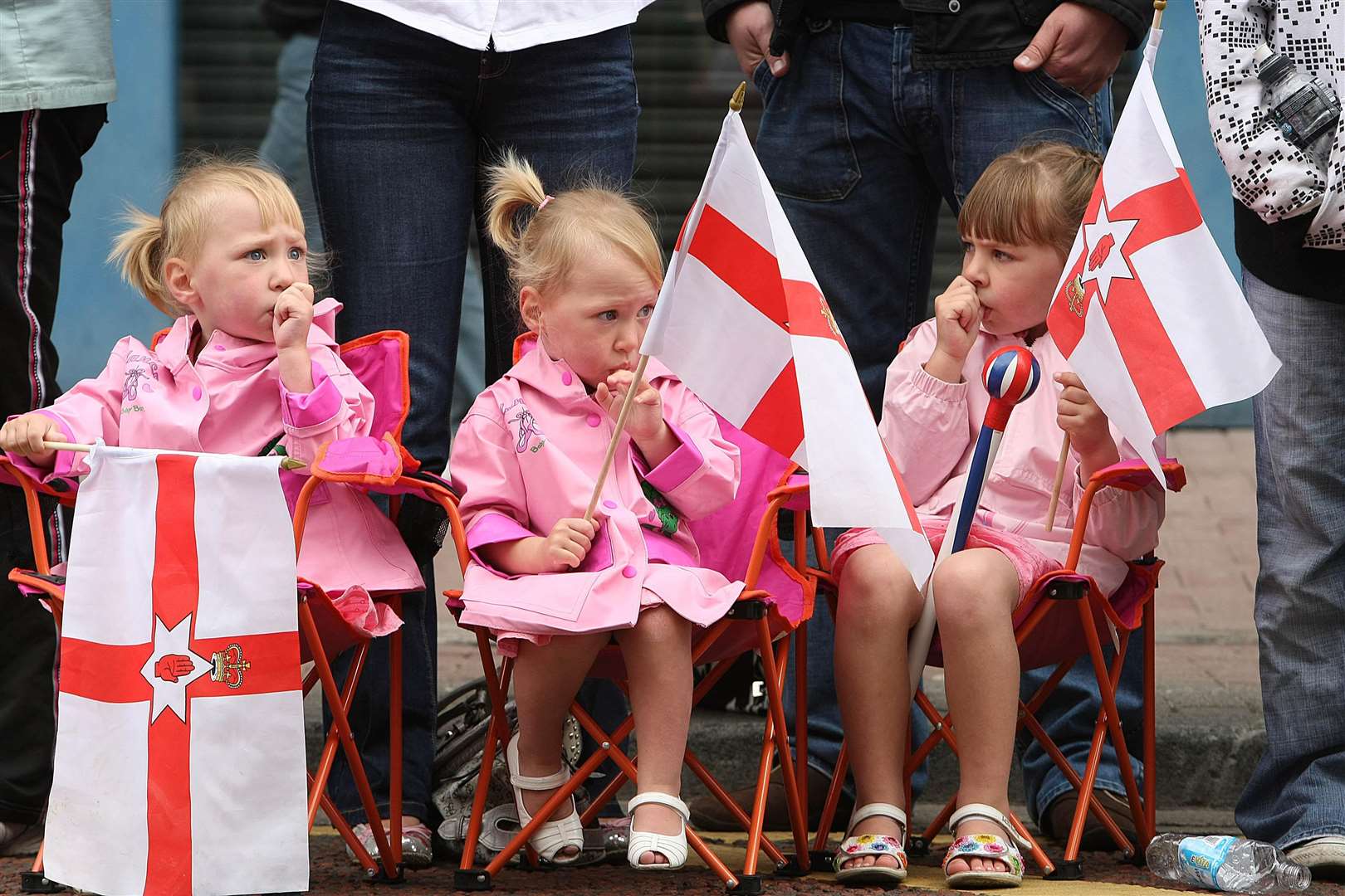 Young girls watch the celebrations in ventral Belfast as the Orange Order and marching bands mark the Battle of the Boyne (PA)