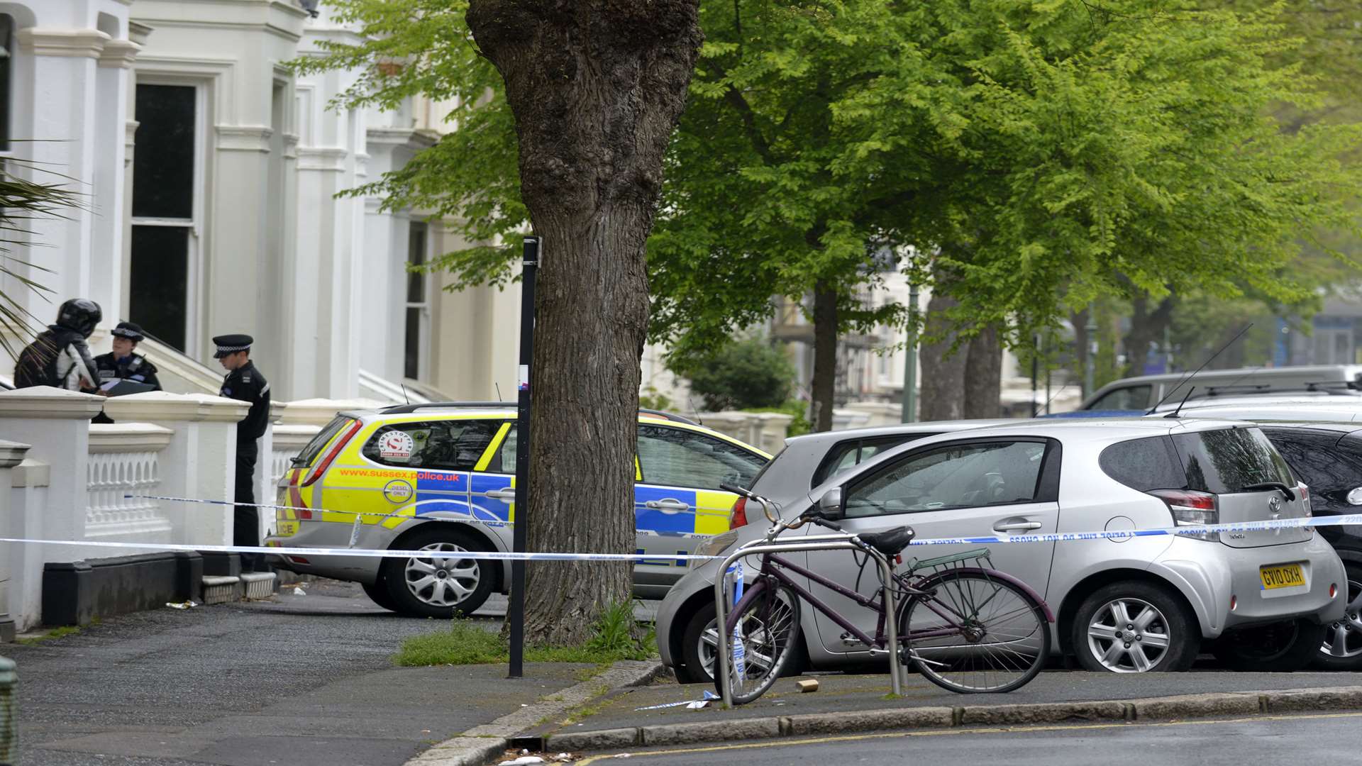 Police talk to neighbours in the street where Xhem Krasniqi was shot dead in Hove. Picture: Terry Applin/The Argus