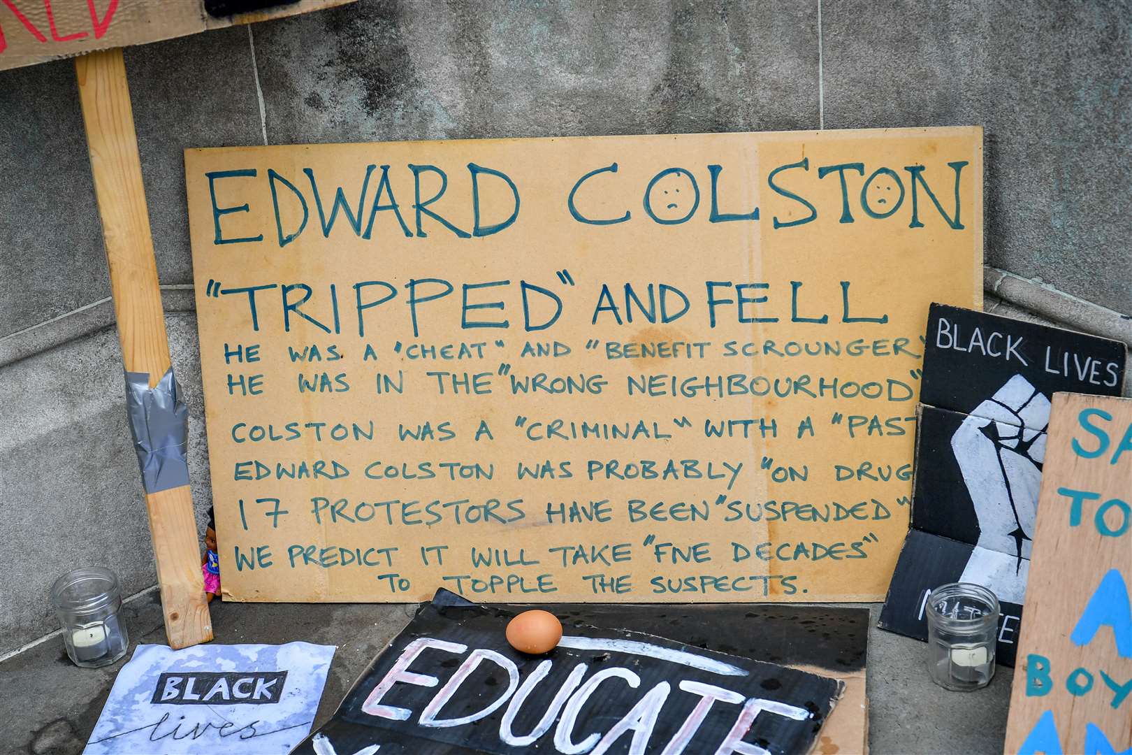 Signs and placards at the base of the Edward Colston statue plinth in Bristol city centre after Black Lives Matter protests toppled the monument (Ben Birchall/PA)