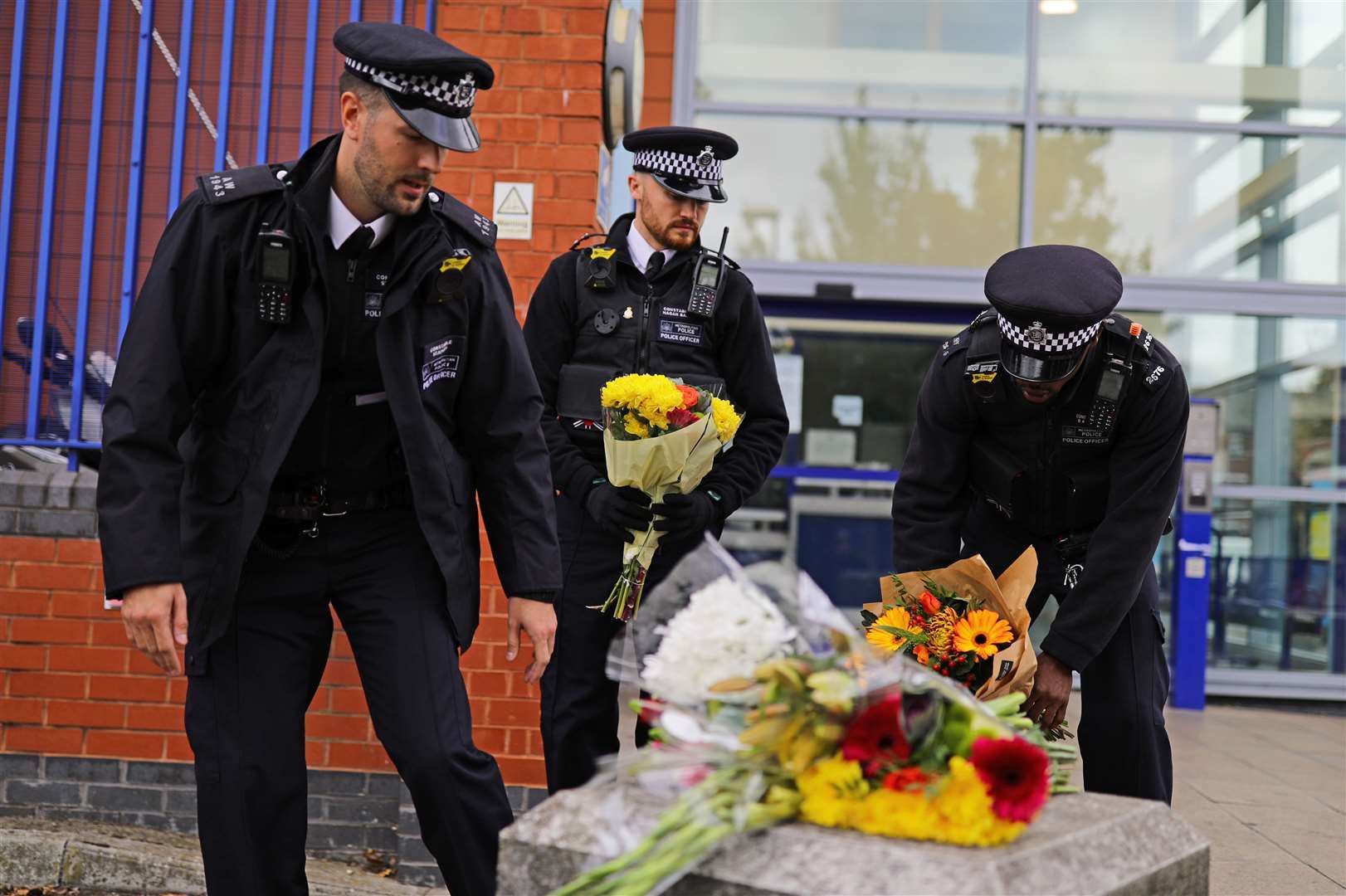 Police officers leave flowers outside Croydon Custody Centre in south London (Aaron Chown/PA)