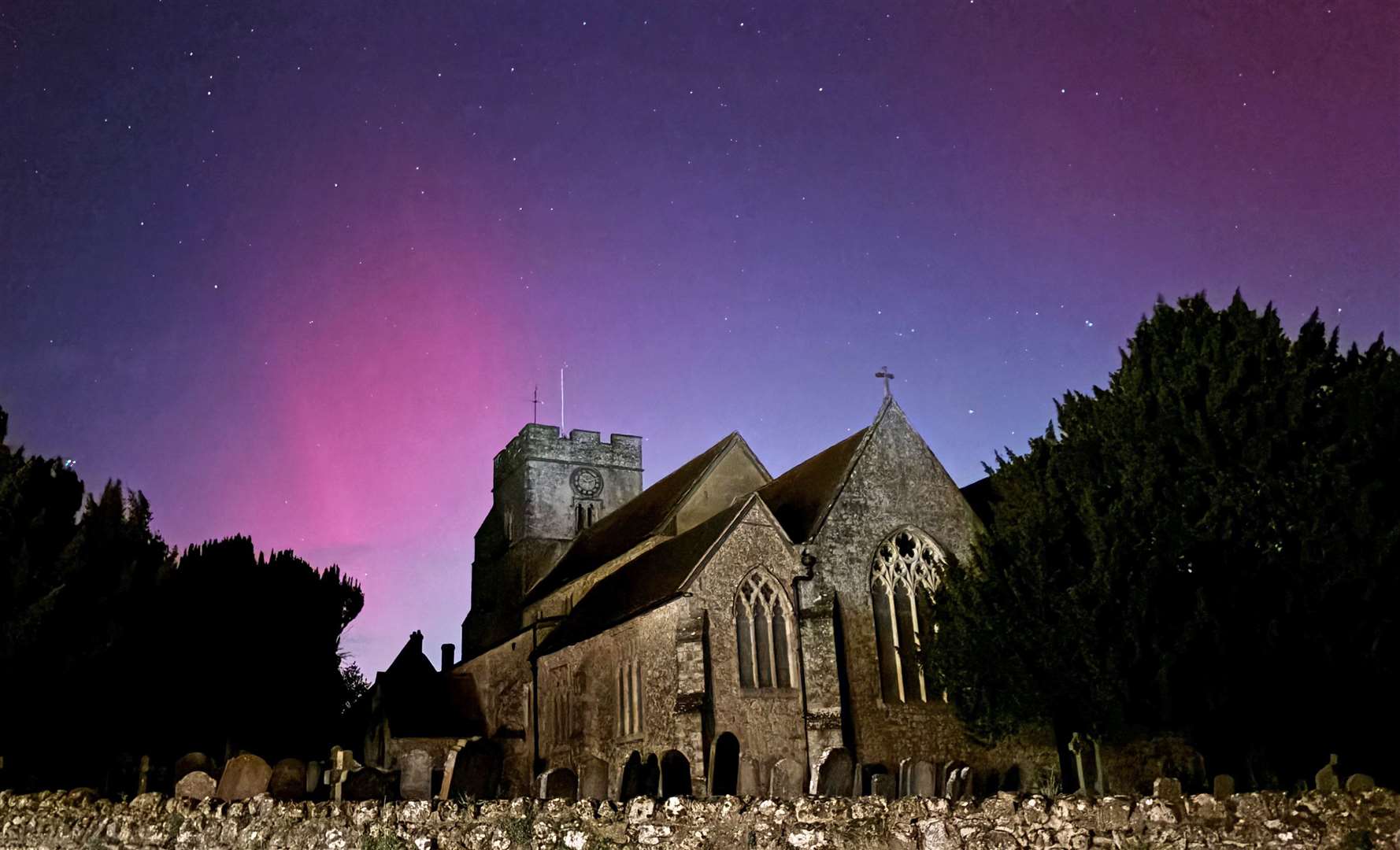 The Northern Lights on display in the skies over Great Chart Church, Ashford, Kent (Gareth Fuller/PA)