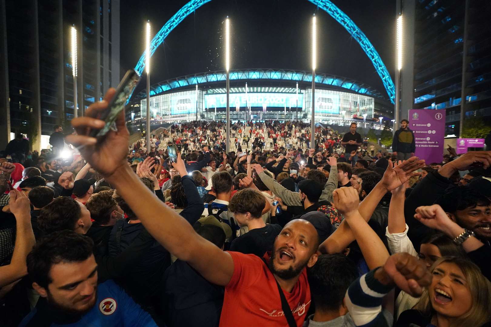 England fans celebrate outside Wembley Stadium after England qualified for the Euro 2020 final (Zac Goodwin/PA)