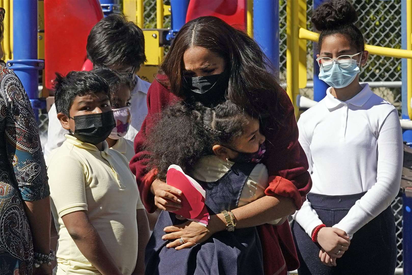 Meghan is hugged by a student (Richard Drew/PA)