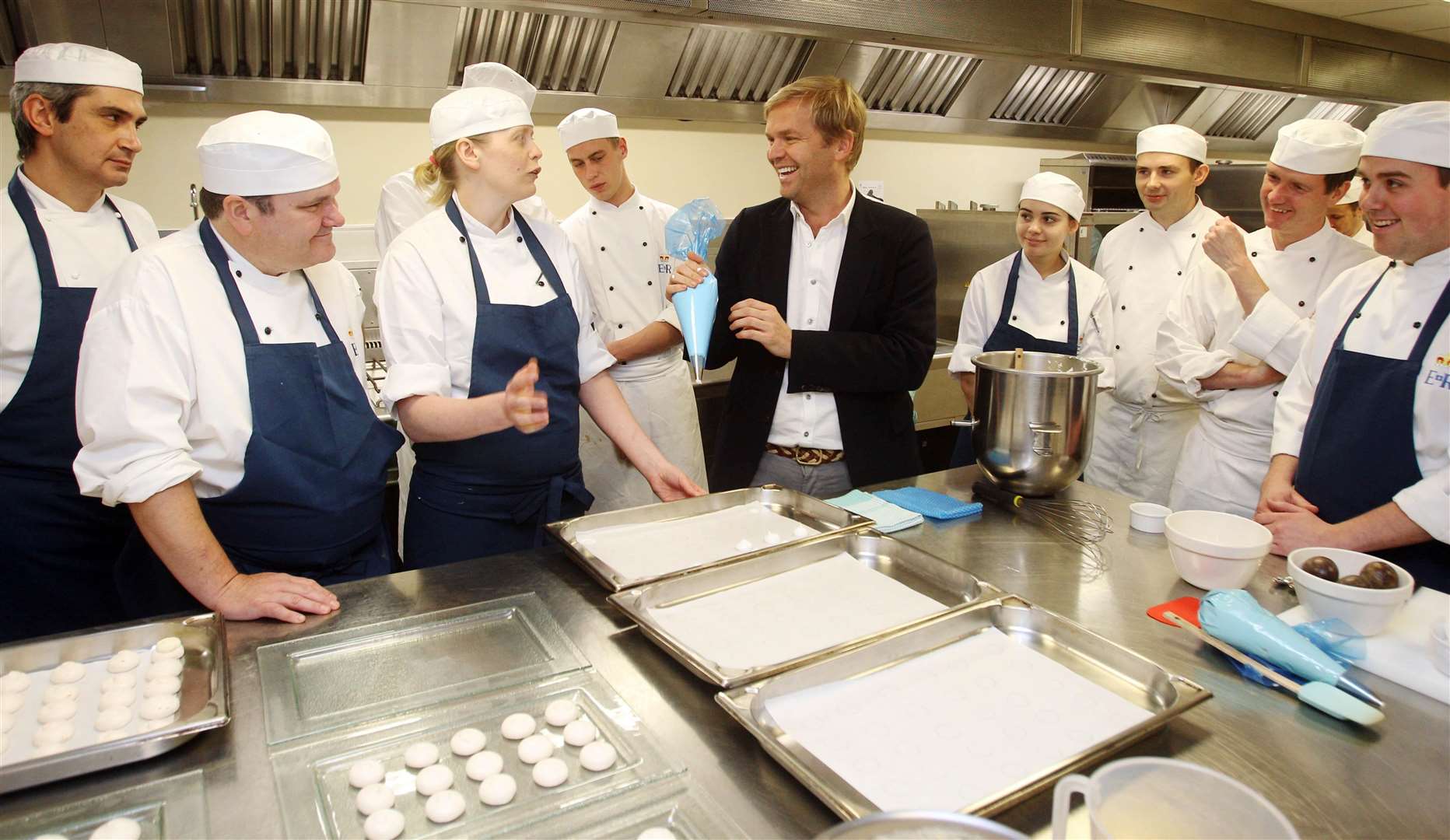 Australian chef and restaurateur Bill Granger with royal pastry chef Kathryn Boyden and other royal chefs in the kitchens at Buckingham Palace as they make pavlova ahead of the reception to be given in advance of the Royal Visit to Australia (Lewis Whyld/PA)