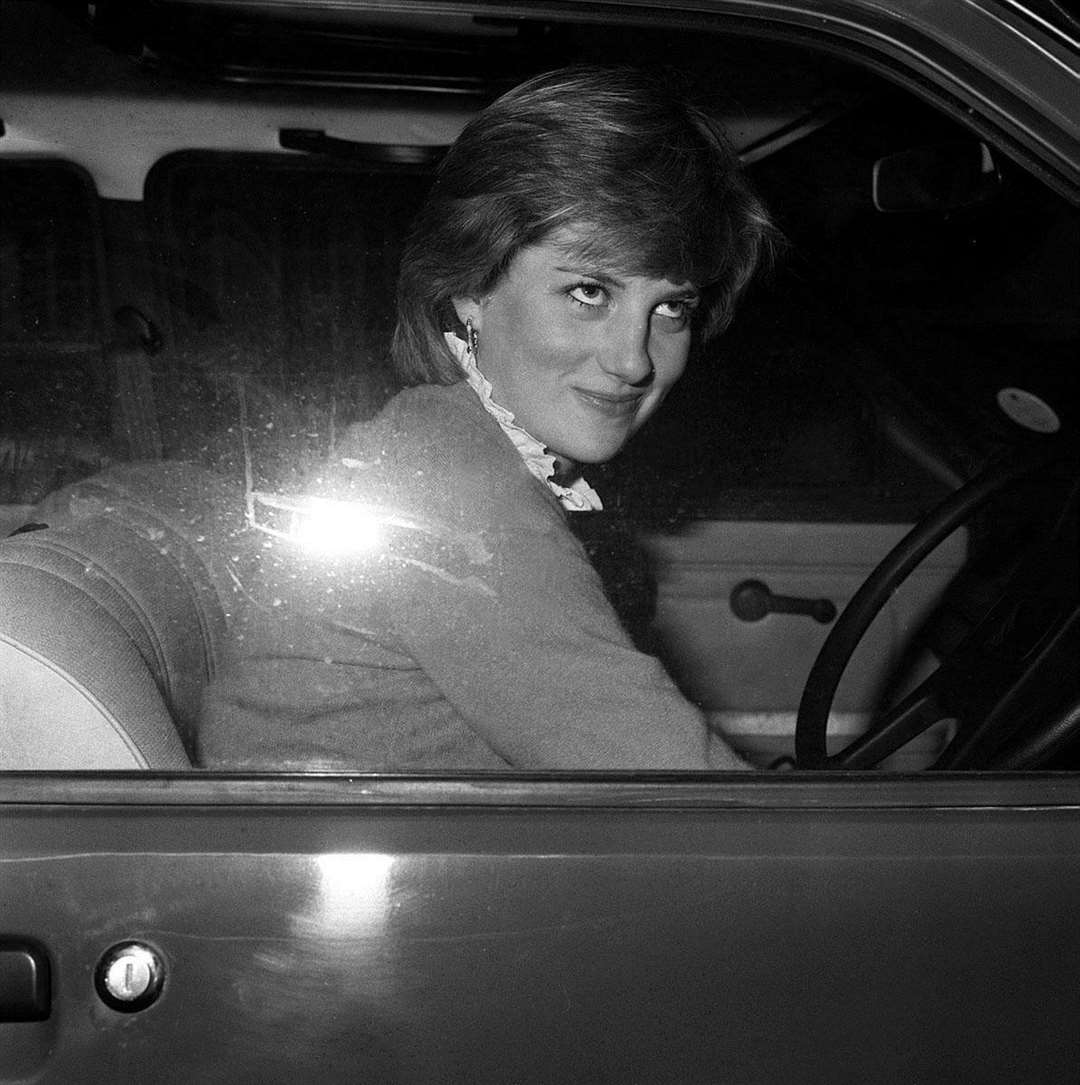 Diana smiles wryly at photographers after she stalls her car outside her flat (PA)