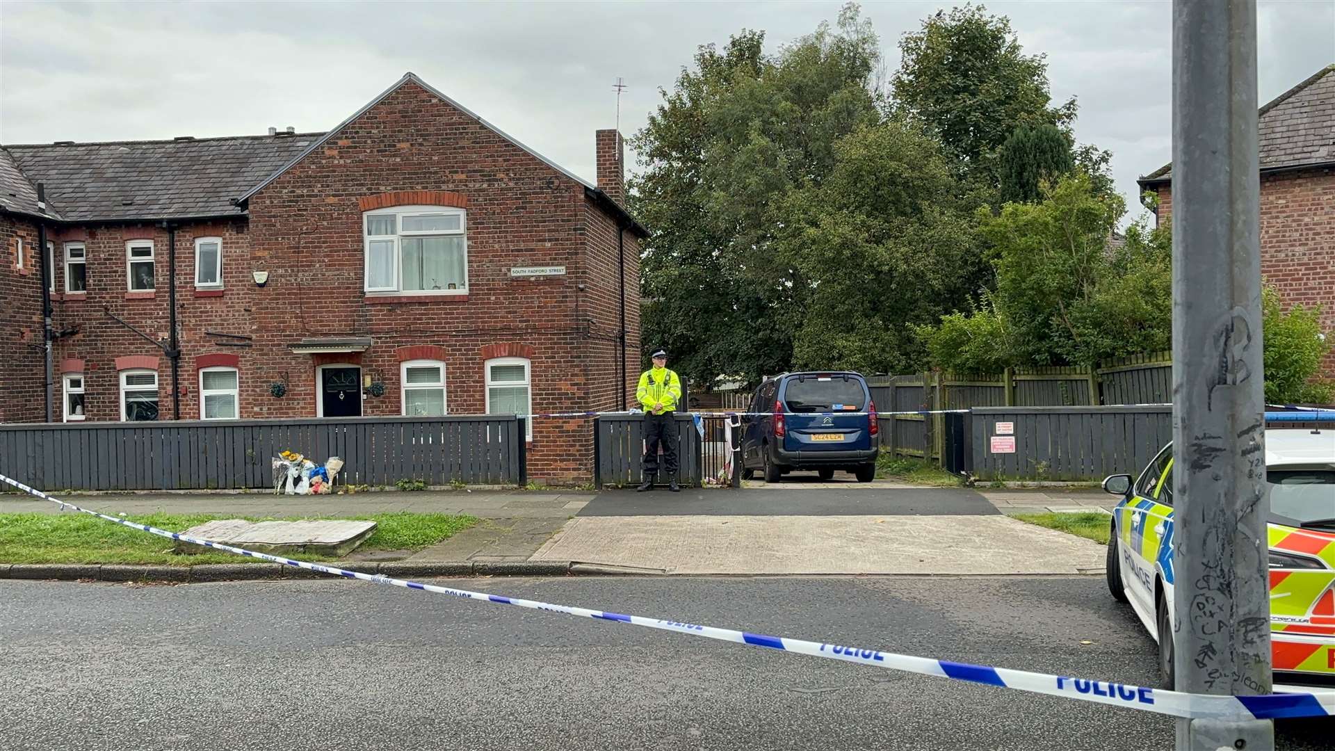 Police outside the property on South Radford Street, Salford, where a woman and her daughter were found dead (Pat Hurst PA)