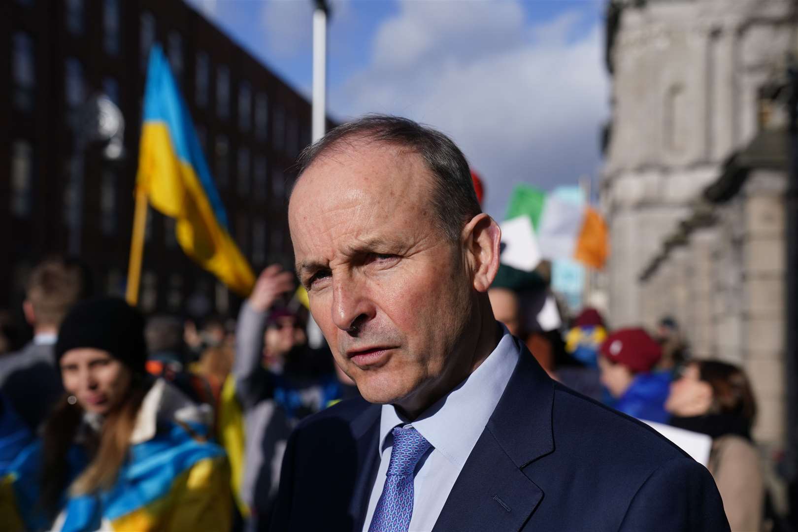 Taoiseach Micheal Martin meets people attending a demonstration outside Leinster House in Dublin to protest the Russian invasion of their country (PA)