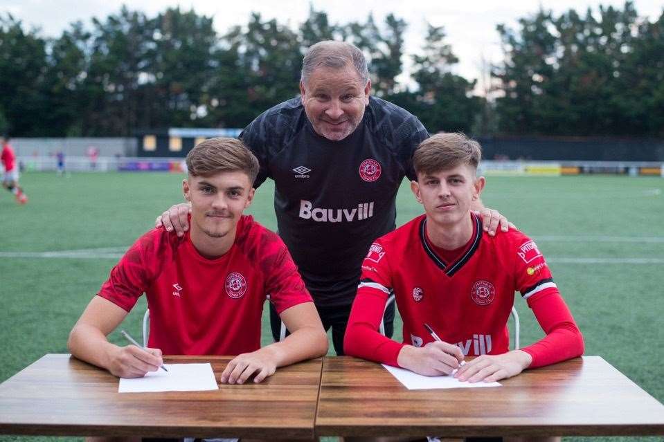 Chatham scholars Michael Paton and Jonny Harris, with boss Kevin Hake, sign first-team contracts before appearing in the second half against Coventry City under-21s Picture: @shotbytxm