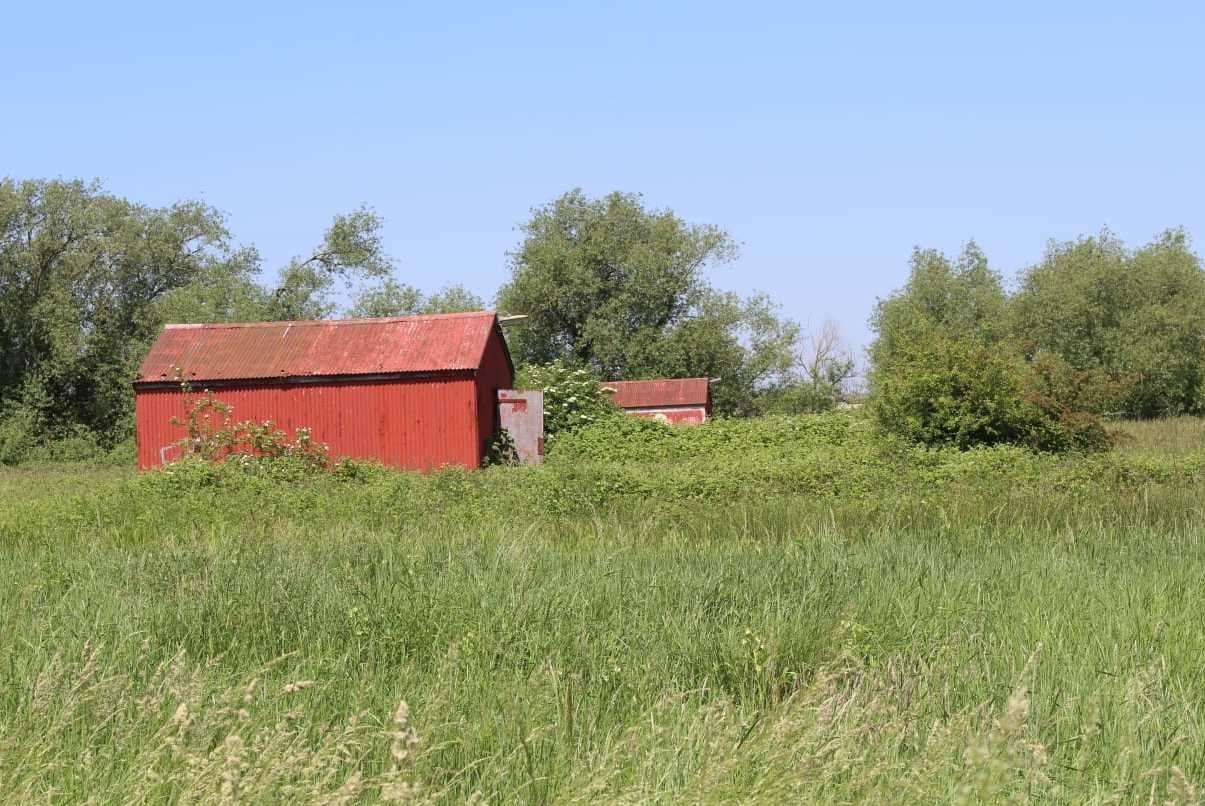 The site was divided into two collections of huts with those working in the brightly coloured huts ordered to work separately from those in the grey to prevent cross-contamination