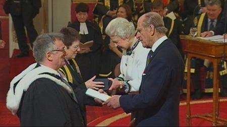 Professor Julia Goodfellow, Vice-Chancellor of the University of Kent, and John Fitzpatrick, Director of Kent Law Clinic and Senior Lecturer at Kent Law School, receive the Law Clinic's Queen's Anniversary Award from the Queen and Duke of Edinburgh.