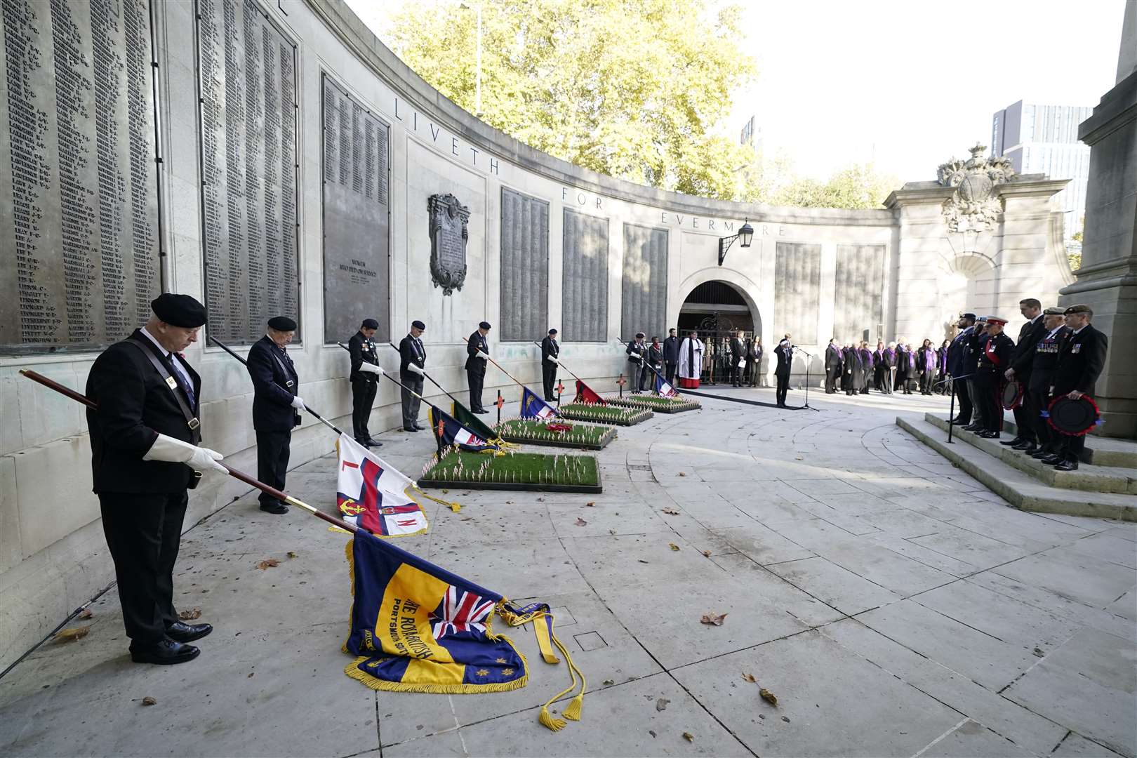 Flag bearers, veterans and members of the public observe a two-minute silence in Guildhall Square, Portsmouth (Andrew Matthews/PA)