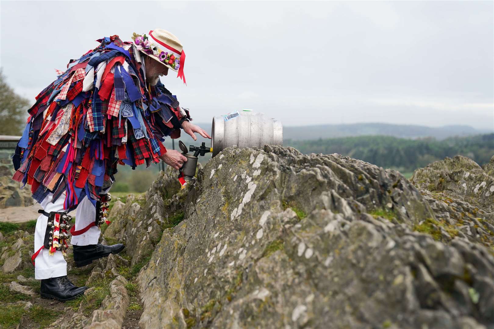 Members of the Leicester Morris Men take refreshments (Jacob King/PA)