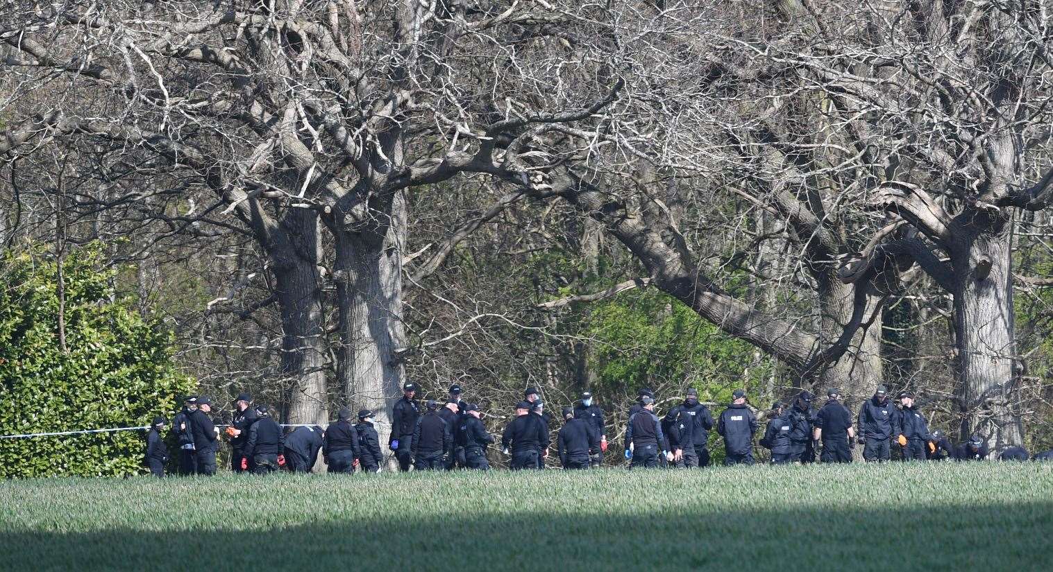 Police officers search a field close to where Ms James’s body was found (Kirsty O’Connor/PA)