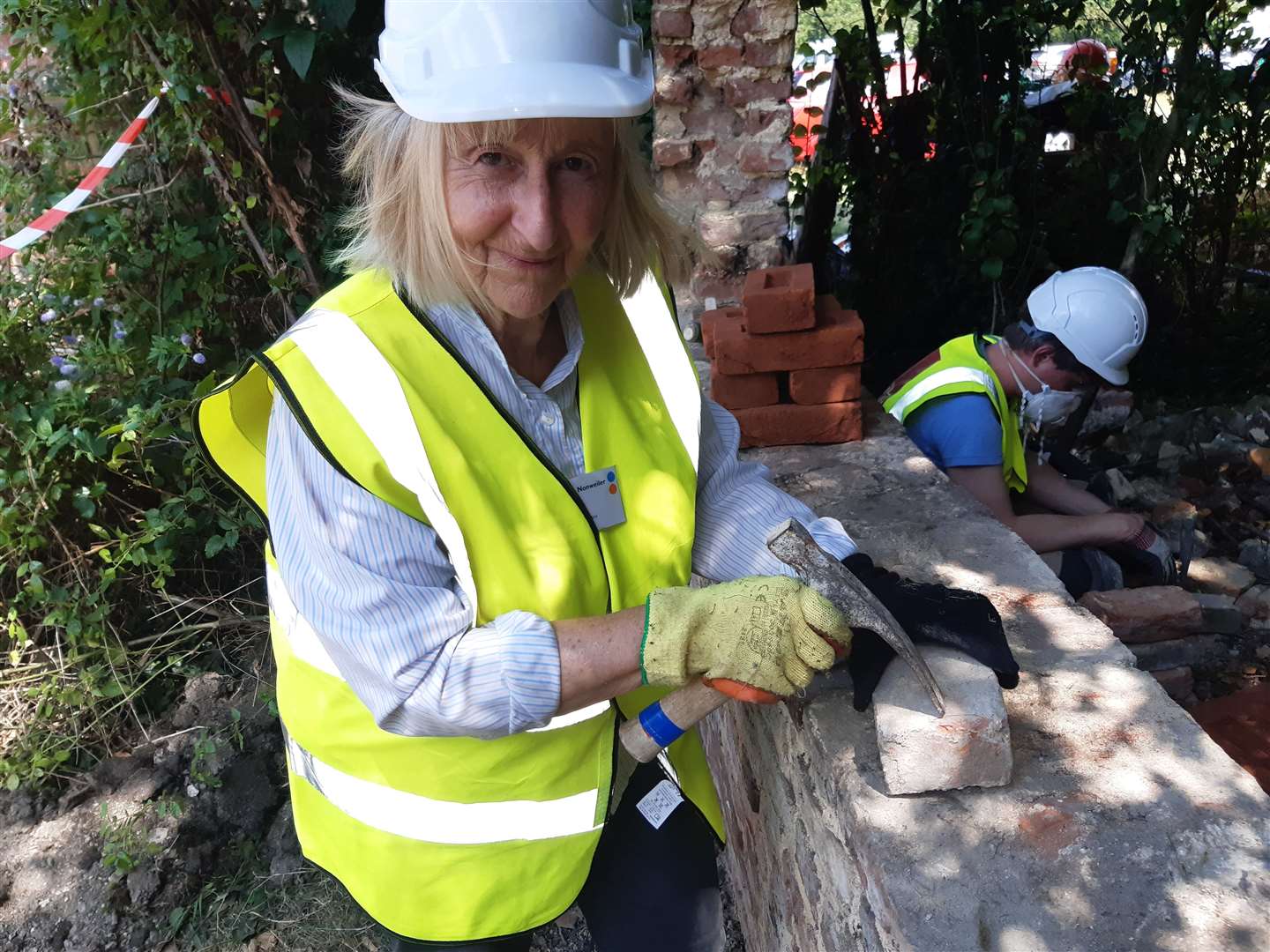 Regular volunteer Caroline Nonweiler cleaning bricks for re-use