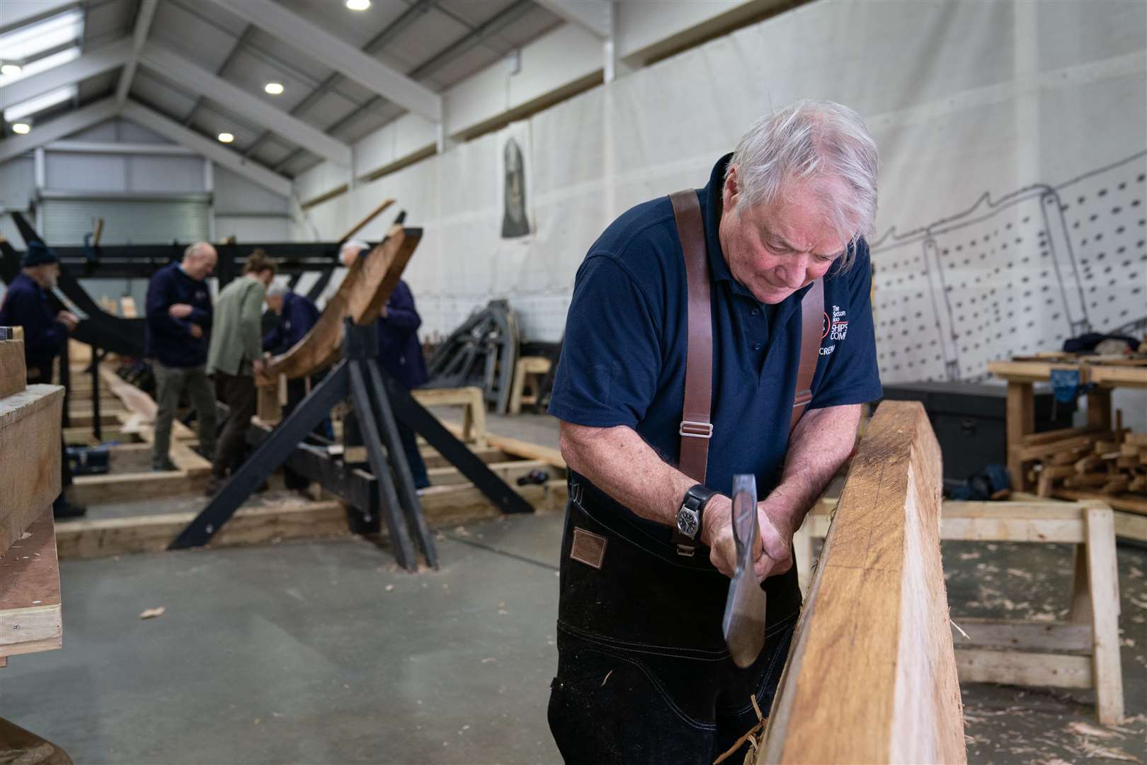 A team of volunteers work on the keel of longship replica (Joe Giddens/PA)