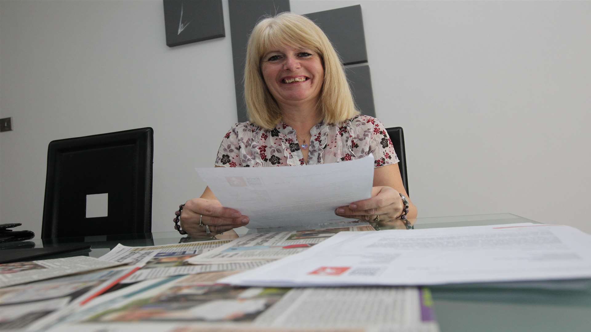 Tina Brooker with some of the paperwork she waded through