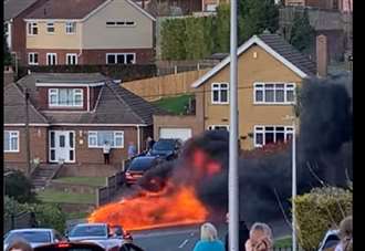 Car bursts into flames after crashing into wall