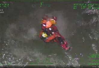 Moment man winched from stormy sea