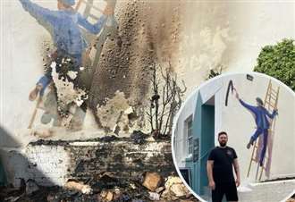 Famous 35-year-old mural restored after arson attack