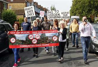 Anti-housing development protesters march through the streets