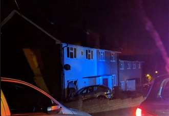 Car crashes through homes front window