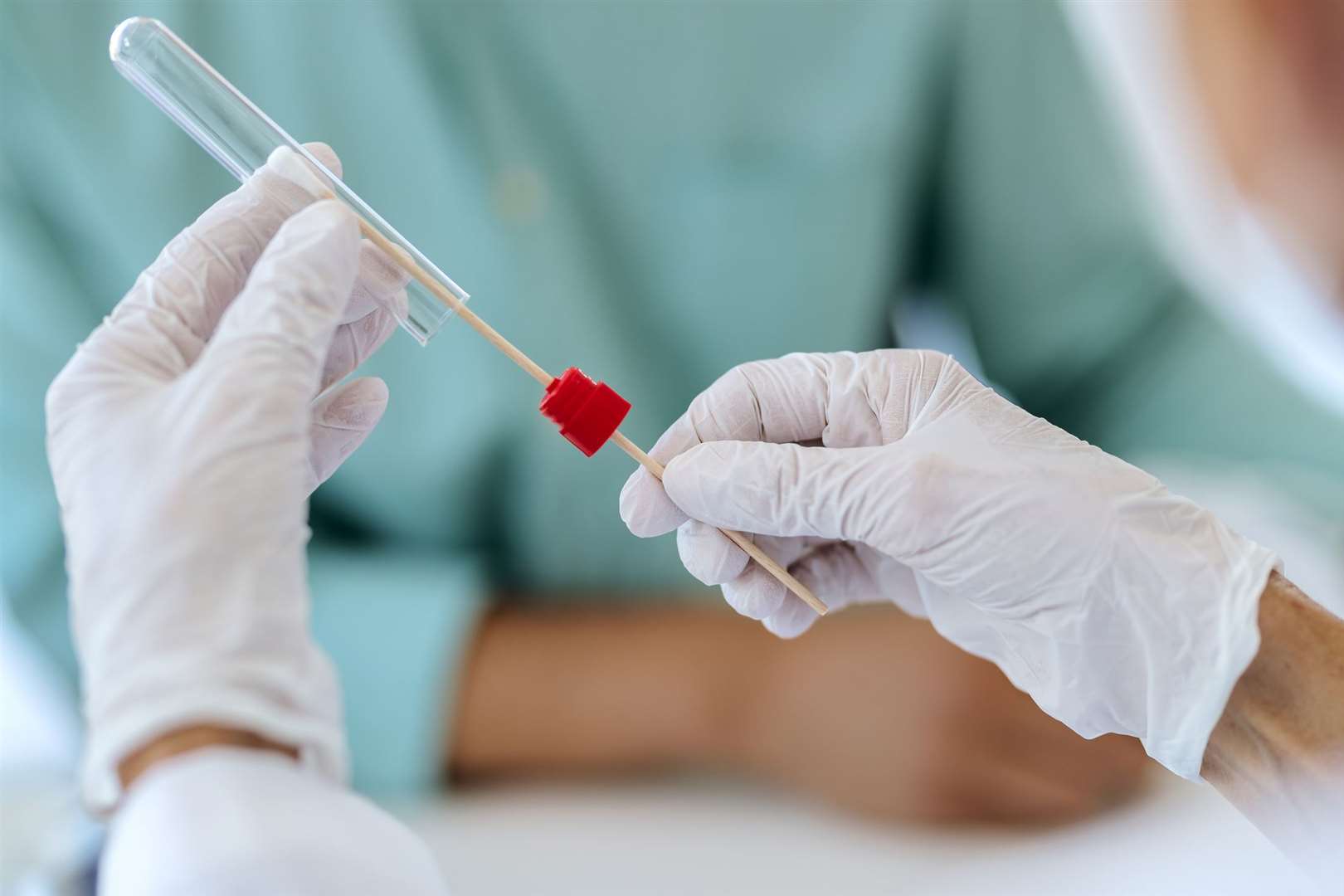 Stock image. Healthcare worker testing a patient for coronavirus