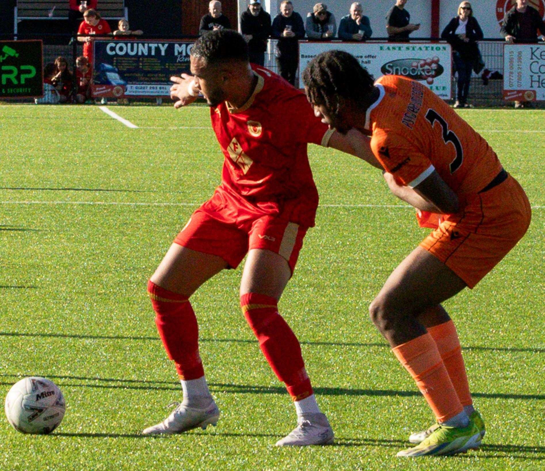 Whitstable scorer Dean Grant holds off Punjab United's Kyden Thomas earlier this month. Picture: Les Biggs