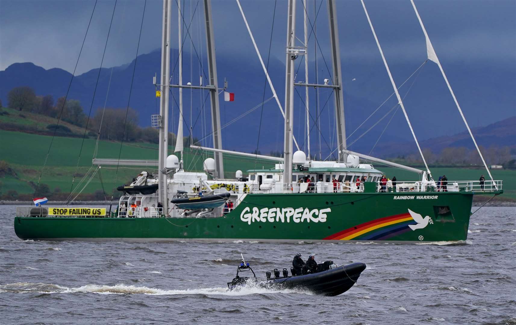 The Greenpeace ship Rainbow Warrior makes its way up the River Clyde, near Greenock carrying four young climate activists from areas affected by climate change (Andrew Milligan/PA)